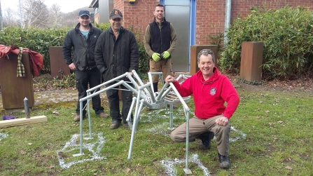Art Oasis project metal spider sculpture being installed in Newtown copyright Montgomeryshire Wildlife Trust