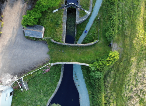 Aerial shot of a bridge over the Montgomery Canal in summer