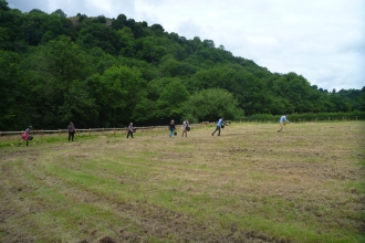 Volunteers scattering seed at Hurdley Meadows