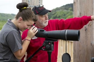 Dyfi Ospreys volunteer at the telescope with a visitor copyright Montgomeryshire Wildlife Trust