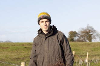 Andy stands by newly planted trees