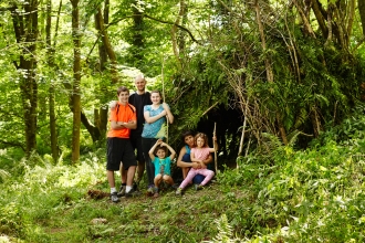 The whole family making a den in the woods