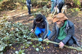 One of the young Wild Skills Wild Spaces participants learns how to safely coppice trees at Severn Farm Pond Nature Reserve copyright Montgomeryshire Wildlife Trust