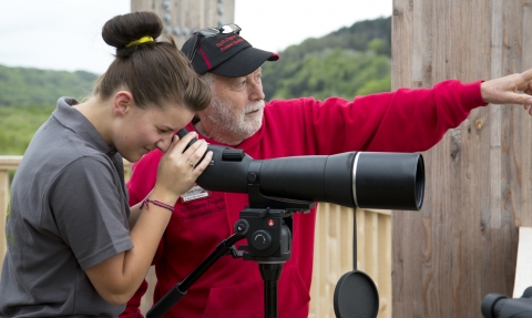 Dyfi Ospreys volunteer at the telescope with a visitor copyright Montgomeryshire Wildlife Trust