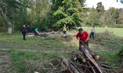 Open Newtown's Countryside Ranger, Dewi Morris, working with volunteers to create habitat piles for wildlife copyright MWT