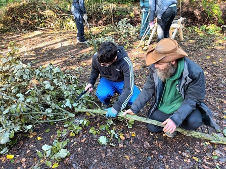 One of the young Wild Skills Wild Spaces participants learns how to safely coppice trees at Severn Farm Pond Nature Reserve copyright Montgomeryshire Wildlife Trust