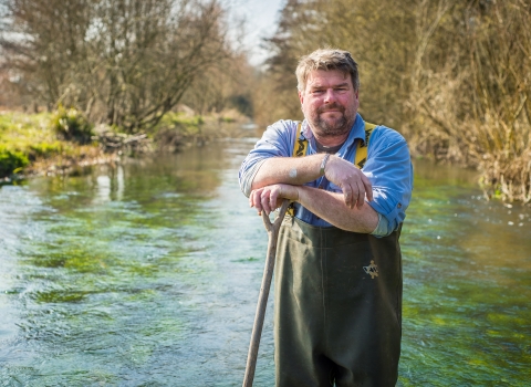 John standing in a river in his waders