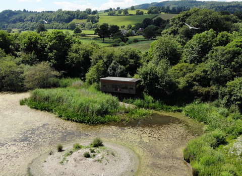 Aerial shot of Llyn Coed y Dinas Nature Reserve and its bird hide