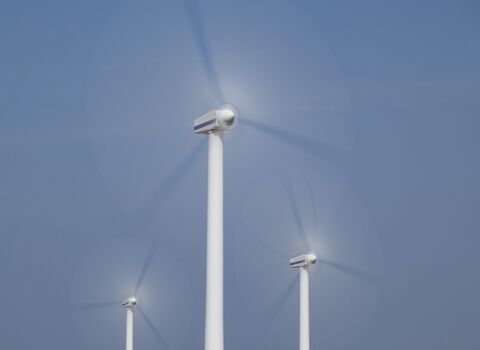 Close up of three wind turbines