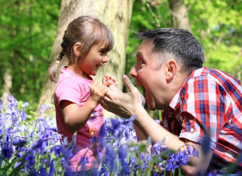 happy parent & child in the bluebells copyright Tom Marshall